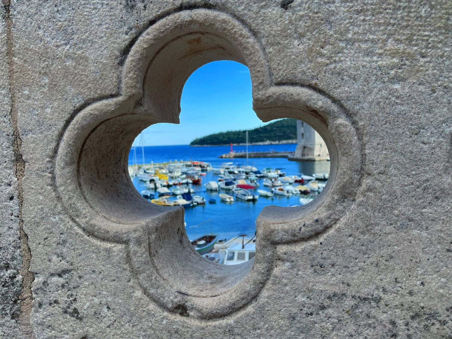 Dubrovnik's Old Port seen through an opening in the city walls