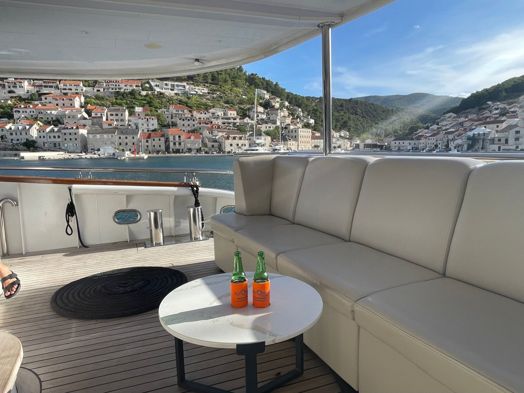 Aft lounge of a private charter yacht with FlyOver Travel koozies, Croatia