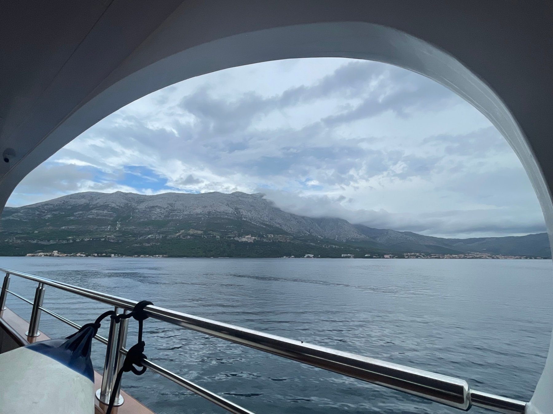 Clouds over the mountains seen from a yacht deck on the Adriatic
