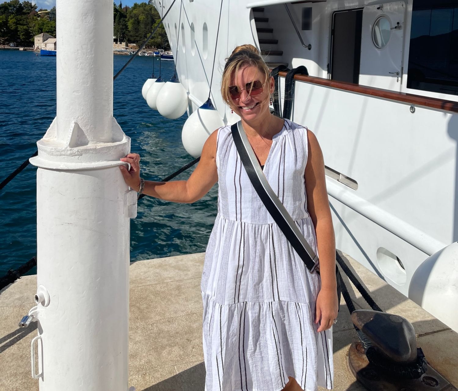Kristin Freeman of FlyOver Travel on the dock beside a private yacht in Croatia